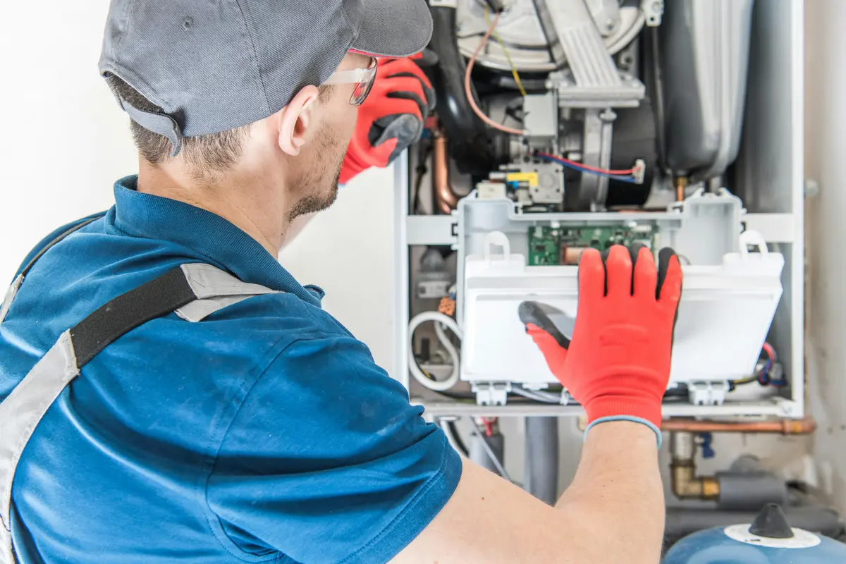 HVAC technician performing annual maintenance on a boiler in Dallas