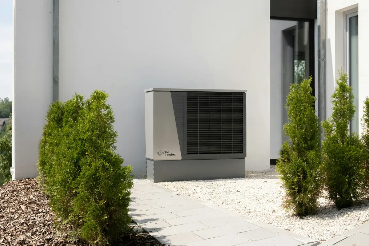 Cold-climate heat pump outdoor unit mounted on Dallas home exterior