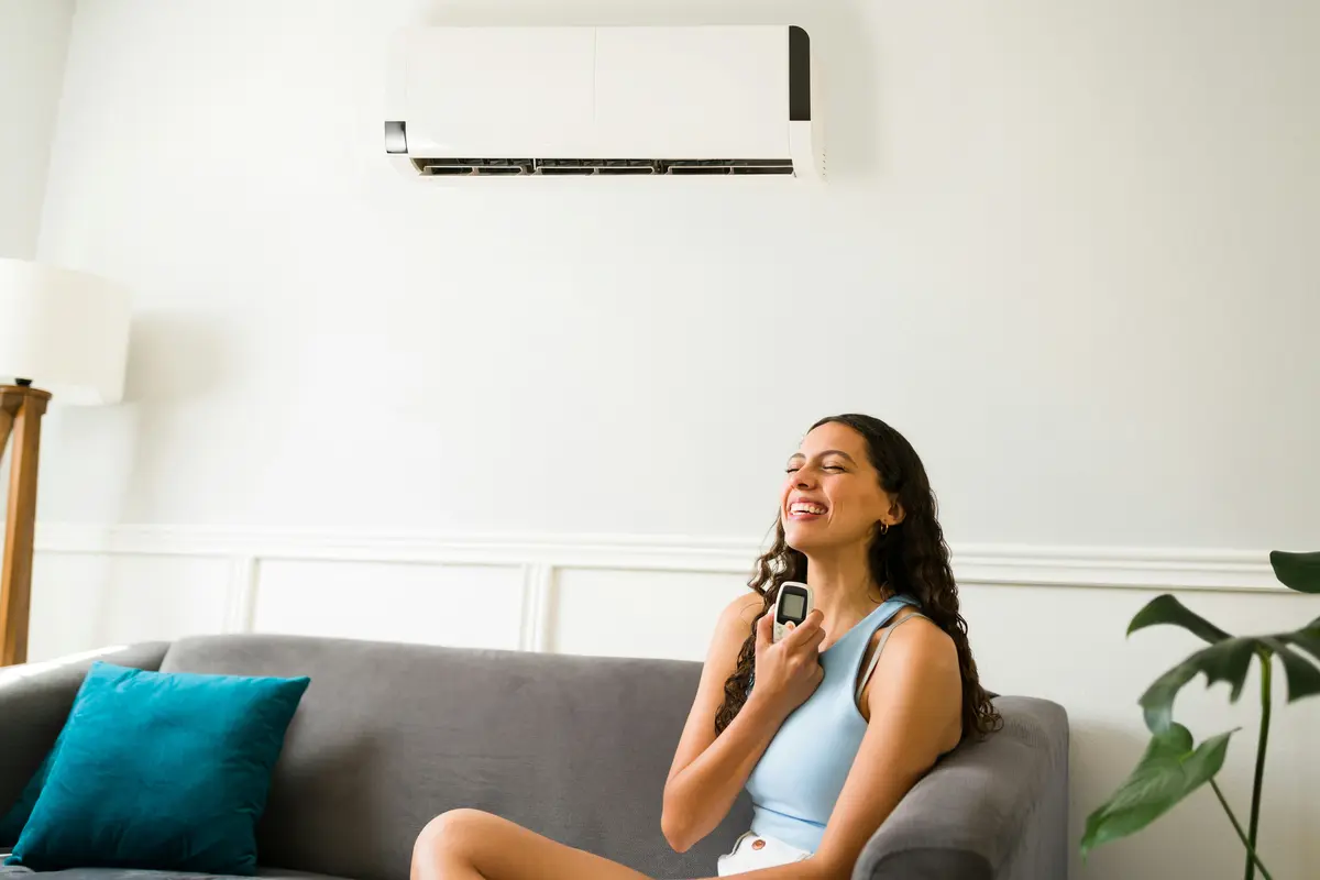 Technician cleaning mini-split indoor unit