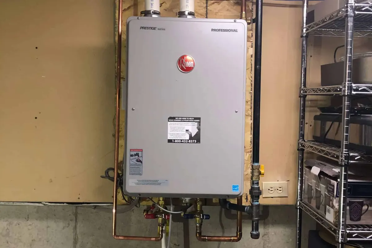Rheem tankless water heater installed on a wall in a Dallas basement